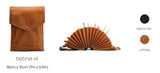 Brown leather pouch and fan-shaped book with 'betina xl' branding on a white background.