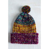 Colorful knitted beanie with a pom-pom on a white background