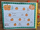 Children's game board with pumpkin-themed rules on a wooden surface.
