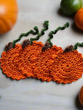 Set of 4 orange pumpkin coasters with brown stems & green trailing leaves