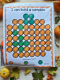 Educational activity sheet titled 'I can build a pumpkin' with colored dots on a wooden surface with pumpkins and leaves.
