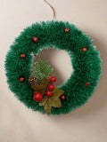 Green tinsel wreath with red bells - 9"diameter